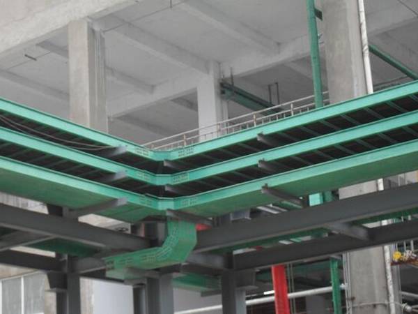 Green FRP channel cable traies are installed on black brackets.