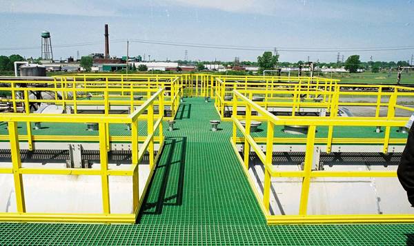 Yellow FRP/GRP handrails and green FRP grating walkways are installed in the waste water treatment plant.