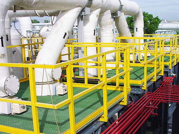FRP/GRP platform with yellow guardrails and green gratings in chemical industries.