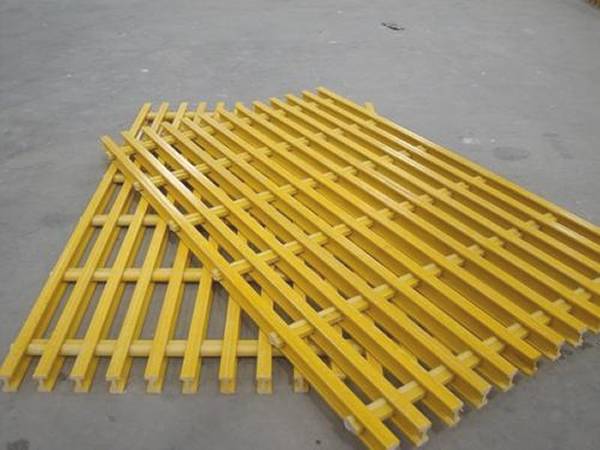Yellow FRP/GRP pultruded gratings on gray background.