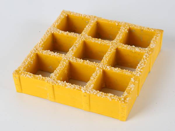 A piece of yellow color molded FRP/GRP grating with gritted surface.