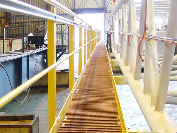 A catwalk on the sea is made of orange pultruded FRP/GRP grating.