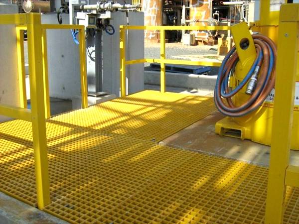 Yellow FRP grating is covering ground in sewage plant.